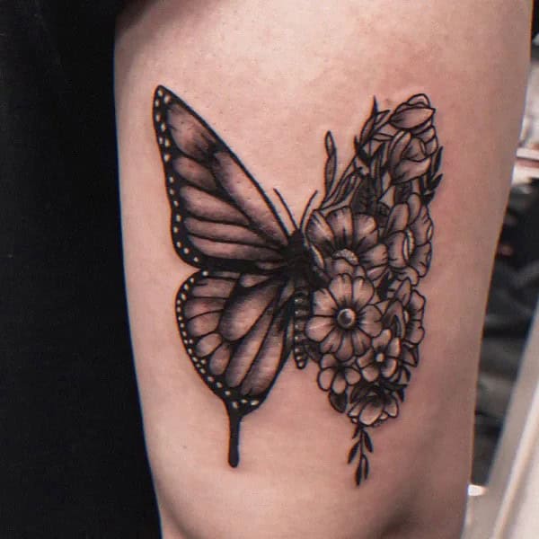 Half butterfly half flower forearm tattoo