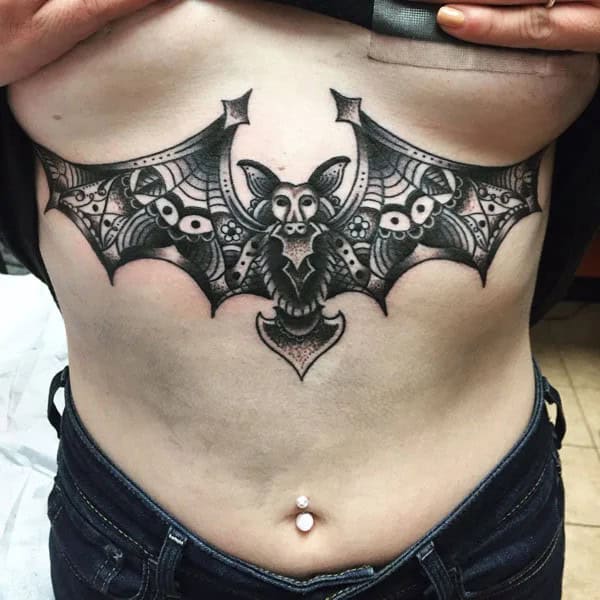 Bat Under Breast Tattoo