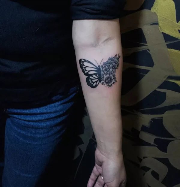 Half butterfly half flower forearm tattoo