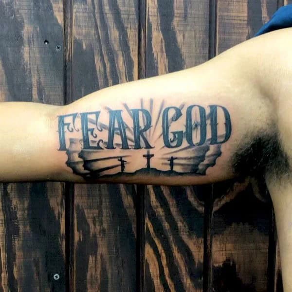 Fear God Tattoo on Bicep