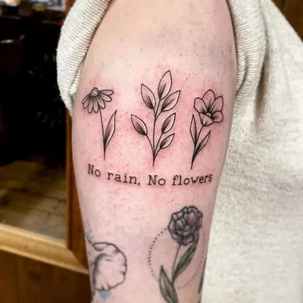 “No Rain No Flowers” Tattoo on Arm