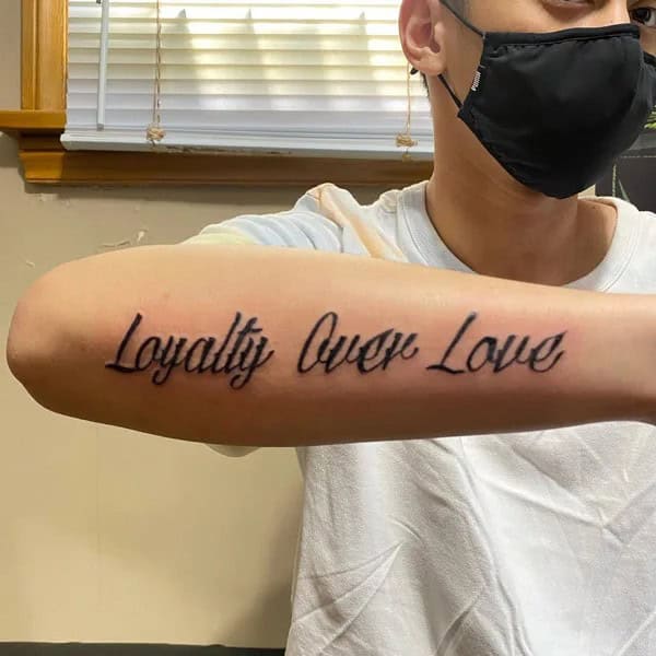 Loyalty Over Love Tattoo On Forearm