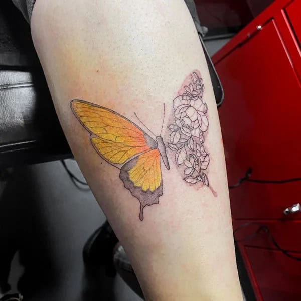 Half butterfly half flower forearm tattoo