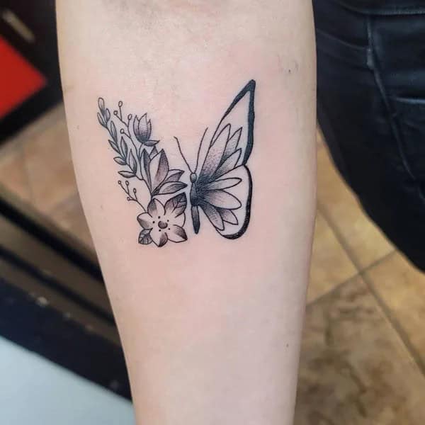 Half butterfly half flower forearm tattoo