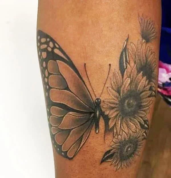 Half butterfly half flower forearm tattoo