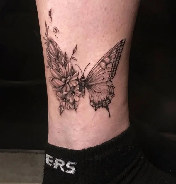 Half butterfly half flower forearm tattoo