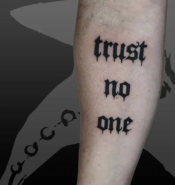 “Trust No One” Tattoo With Block Letters