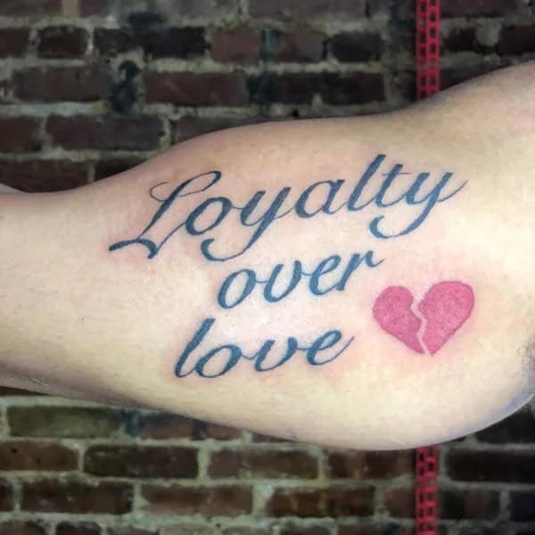 Loyalty Over Love Tattoo On Bicep