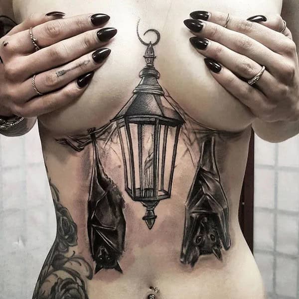 Bat Under Breast Tattoo