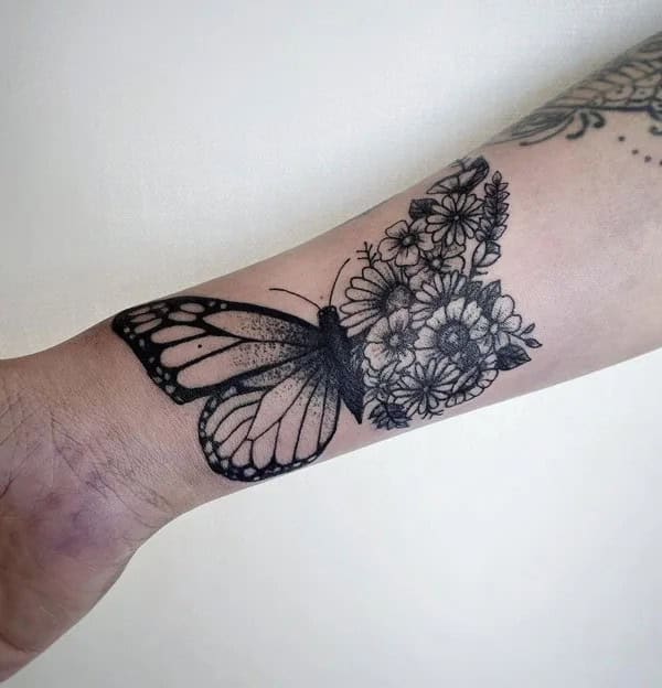 Half butterfly half flower forearm tattoo