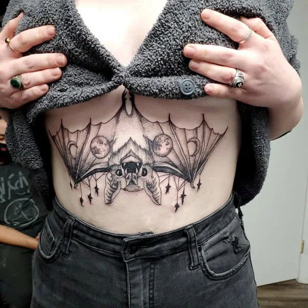 Bat Under Breast Tattoo